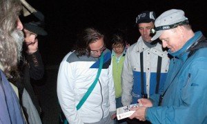 Referencing the field guild to identify a month on the Fall BioBlitz hike at Mud Lake.