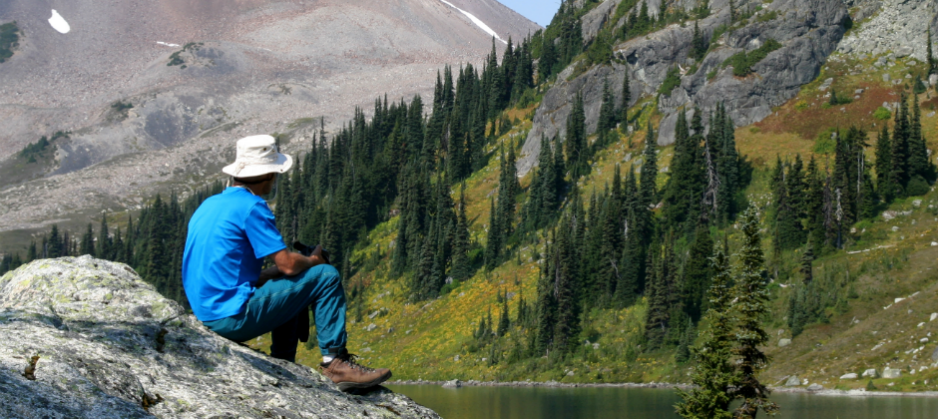 Image of a hiker, lake and mountain