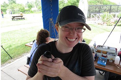 Image of a girl banning a Purple Martin