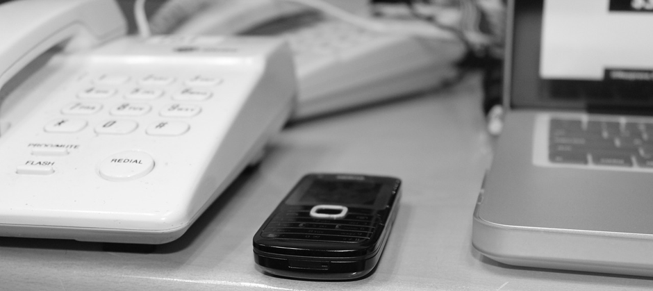 image of a cellphone and landline