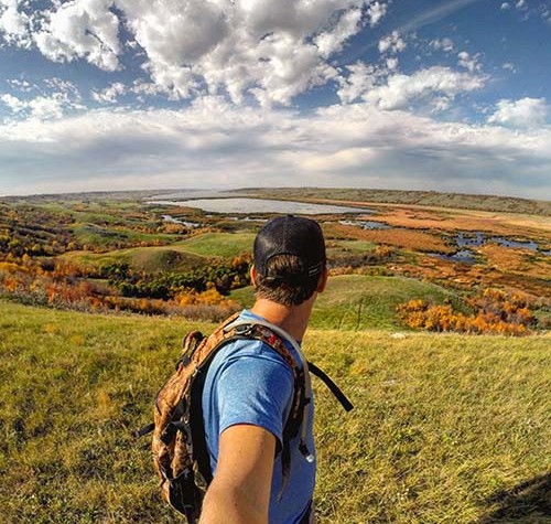 Image of a man hiking in Saskatchewan in the fall