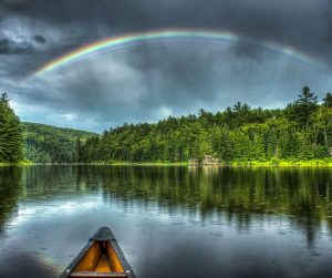 Image of a canoe and rainbow